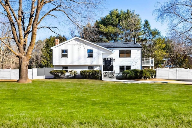 raised ranch featuring a front yard