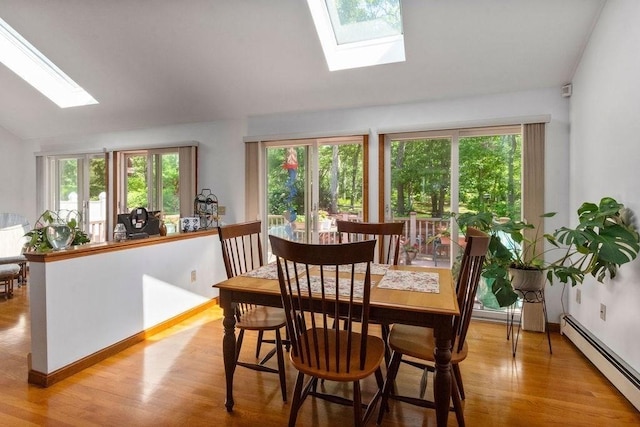 344 Mayfair Rd, Dennis, MA 02660 - dining room with a skylight, baseboard heating, vaulted ceiling, and wood finished floors