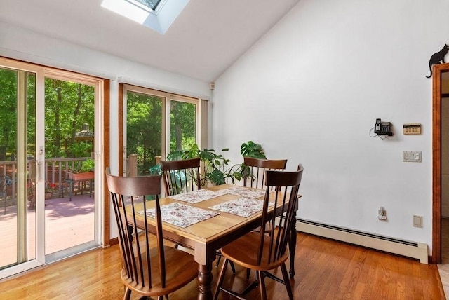 344 Mayfair Rd, Dennis, MA 02660 - dining space with baseboard heating, vaulted ceiling, a skylight, and light wood-type flooring