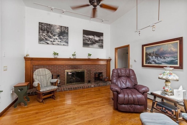 344 Mayfair Rd, Dennis, MA 02660 - living area featuring track lighting, ceiling fan, light wood-style floors, and a fireplace