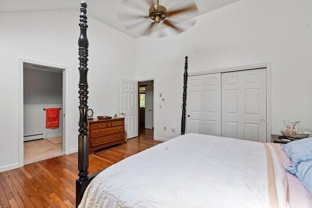 344 Mayfair Rd, Dennis, MA 02660 - bedroom featuring wood finished floors, baseboard heating, a closet, connected bathroom, and high vaulted ceiling