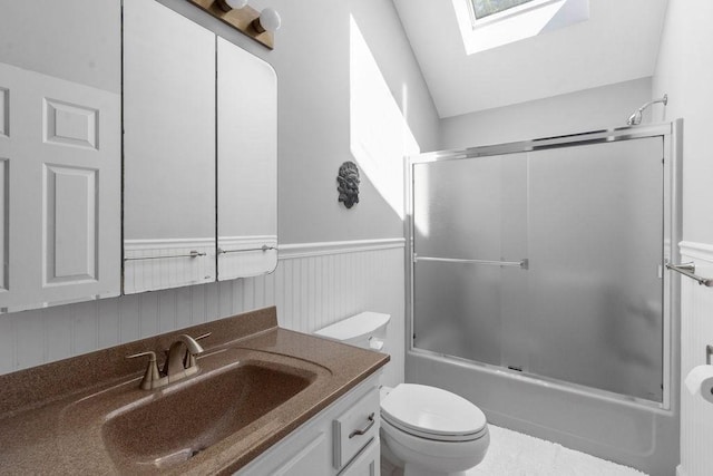 344 Mayfair Rd, Dennis, MA 02660 - bathroom featuring a skylight, vanity, wainscoting, and enclosed tub / shower combo