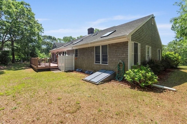 344 Mayfair Rd, Dennis, MA 02660 - rear view of house featuring a deck, a yard, a chimney, and a shingled roof