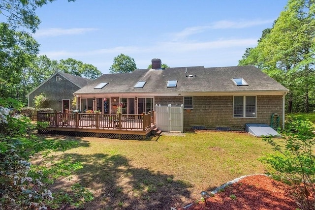 344 Mayfair Rd, Dennis, MA 02660 - back of property with a deck, a lawn, a chimney, and a shingled roof