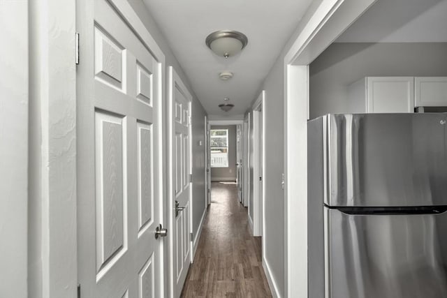 hallway with dark hardwood / wood-style flooring