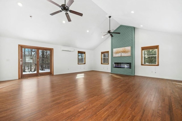 unfurnished living room featuring high vaulted ceiling, a wall unit AC, a fireplace, a ceiling fan, and dark wood-style floors