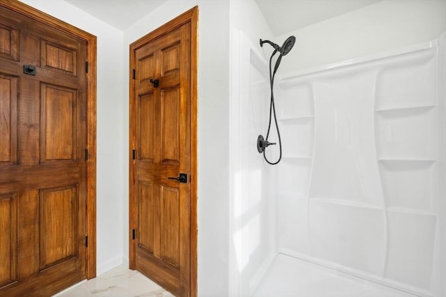 full bathroom with a stall shower and marble finish floor