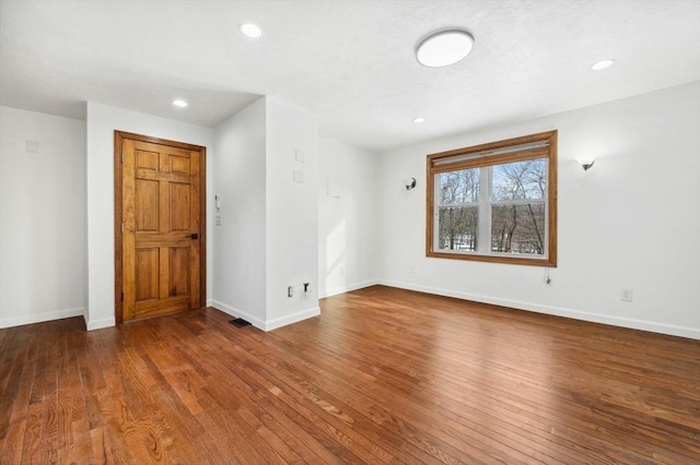 spare room with recessed lighting, baseboards, and hardwood / wood-style floors