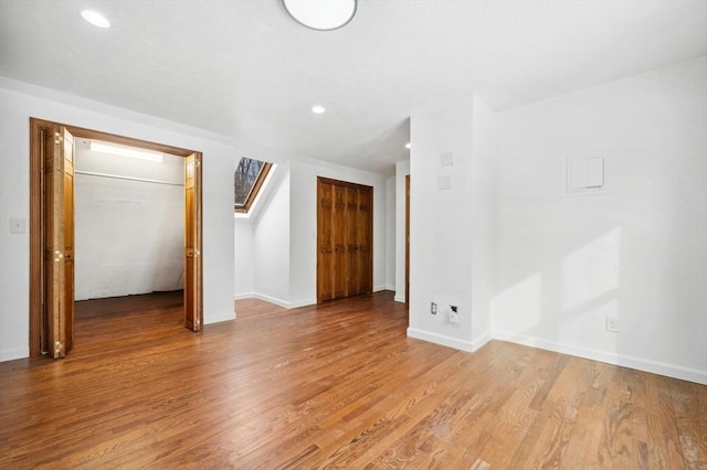 interior space with a closet, recessed lighting, light wood-style flooring, and baseboards