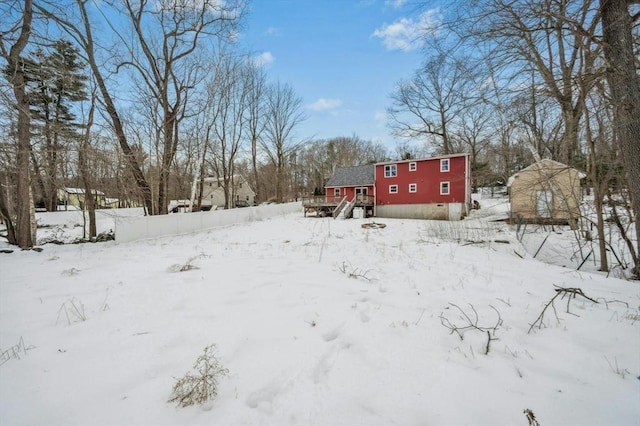 snowy yard featuring a wooden deck