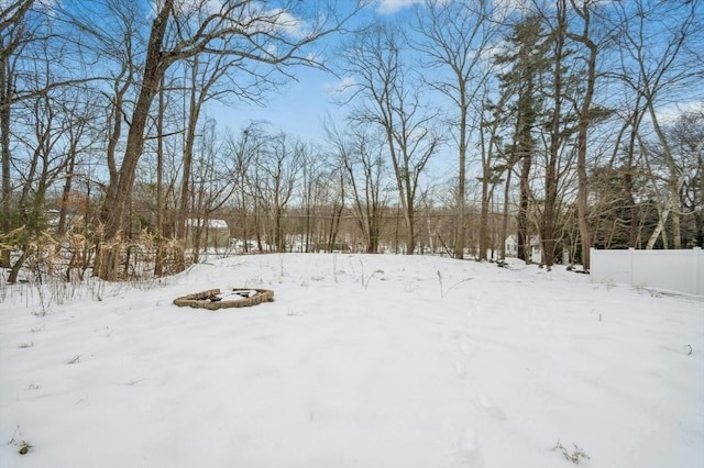 snowy yard featuring fence