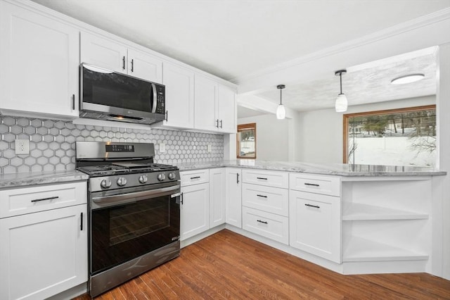 kitchen featuring decorative backsplash, appliances with stainless steel finishes, white cabinets, and wood finished floors