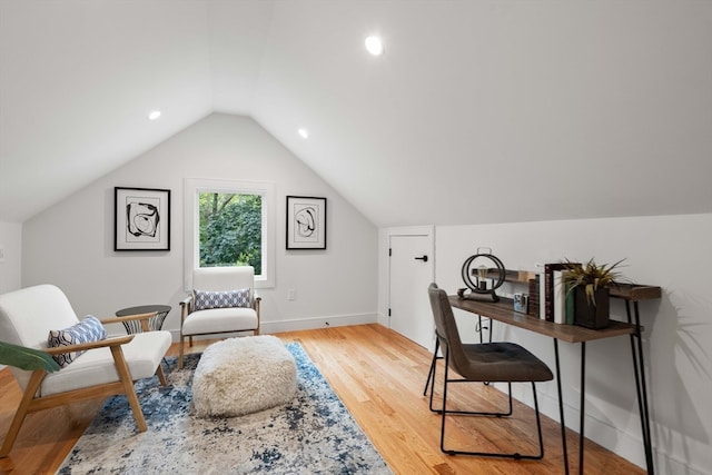 home office featuring hardwood / wood-style flooring and lofted ceiling