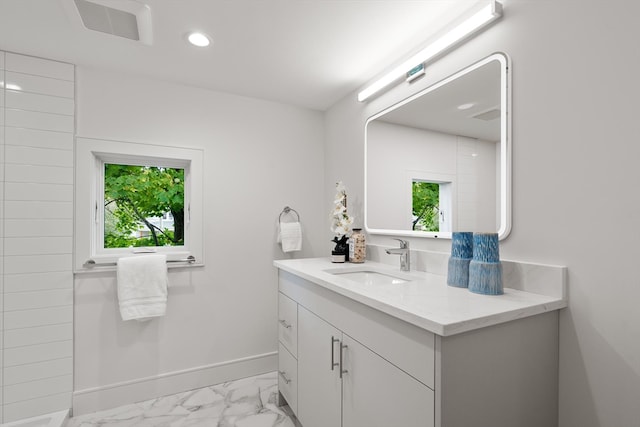 bathroom with plenty of natural light and vanity