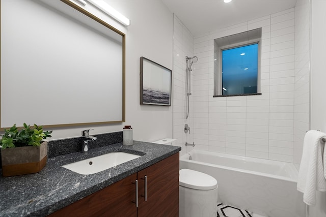 full bathroom with vanity, tiled shower / bath combo, and toilet