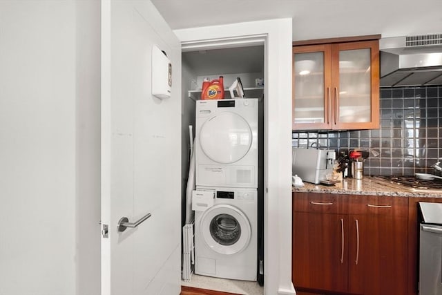 laundry room featuring stacked washer and dryer and laundry area