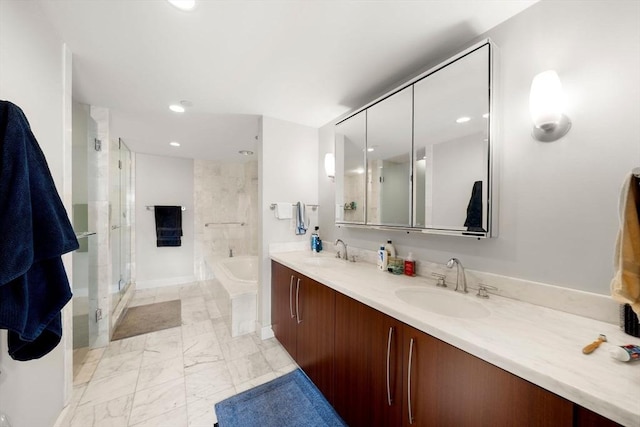 bathroom featuring marble finish floor, a sink, a bath, and a stall shower