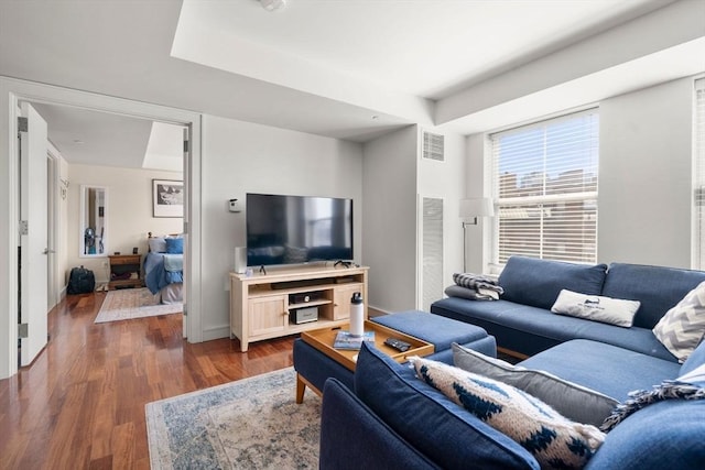 living room featuring visible vents and wood finished floors