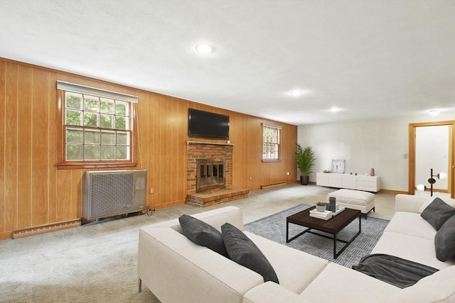 9 Divittorio Dr, Milford, MA 01757 - living room featuring baseboard heating, plenty of natural light, baseboards, a brick fireplace, and wood walls