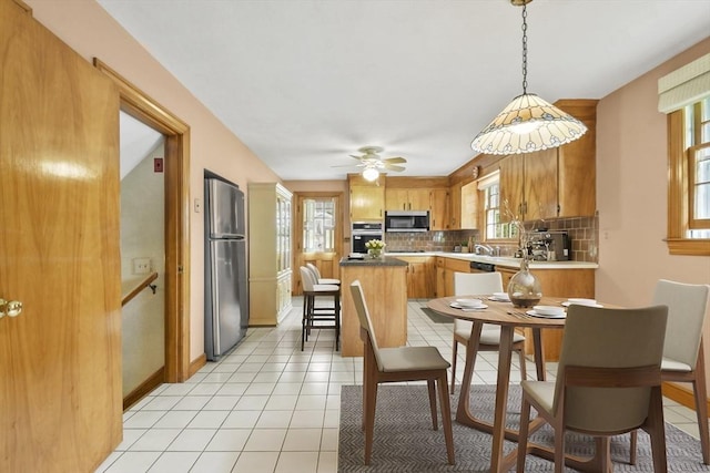 9 Divittorio Dr, Milford, MA 01757 - dining area with light tile patterned floors, baseboards, and ceiling fan