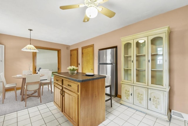 9 Divittorio Dr, Milford, MA 01757 - kitchen with freestanding refrigerator, dark countertops, a kitchen island, ceiling fan, and pendant lighting
