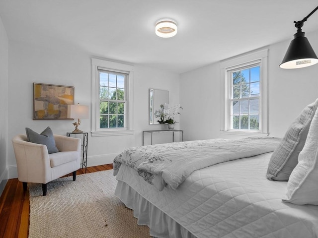 bedroom featuring baseboards and wood finished floors