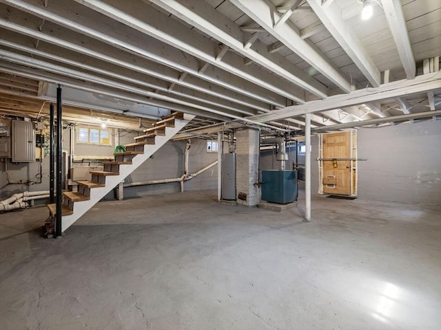 below grade area with water heater, stairway, and electric panel