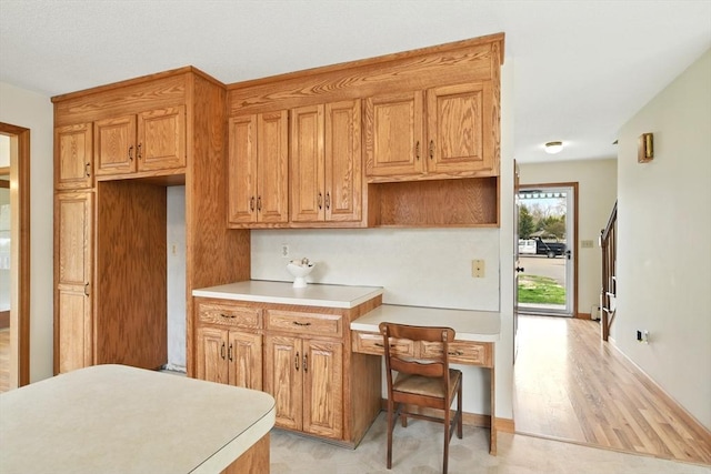 kitchen featuring light countertops and brown cabinets