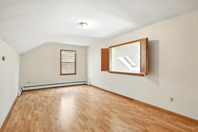 bonus room featuring light wood-style floors, baseboards, baseboard heating, and lofted ceiling