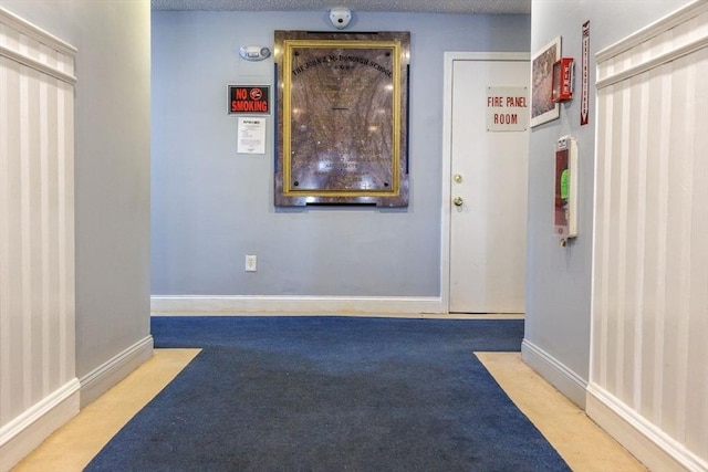 interior space with carpet flooring and a textured ceiling