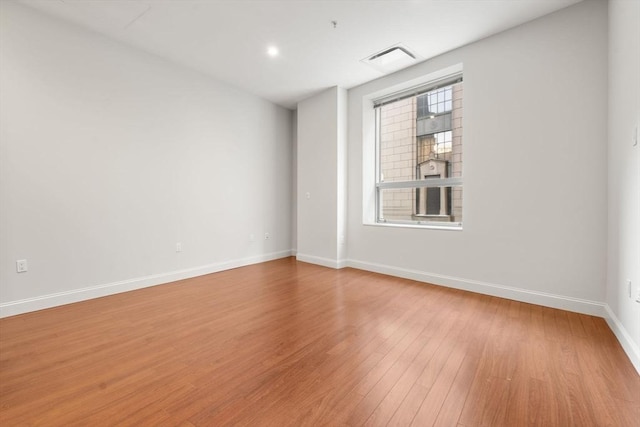 empty room with light hardwood / wood-style floors