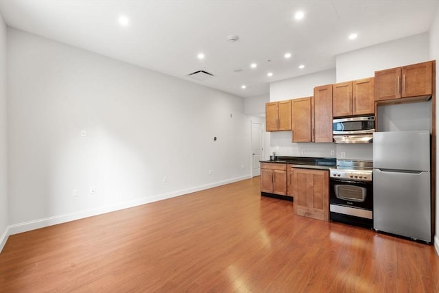 kitchen with stainless steel appliances and dark hardwood / wood-style flooring