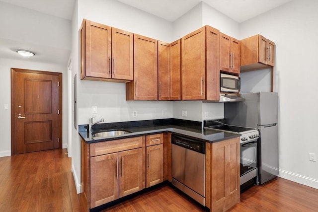 kitchen with sink, dark hardwood / wood-style floors, and appliances with stainless steel finishes