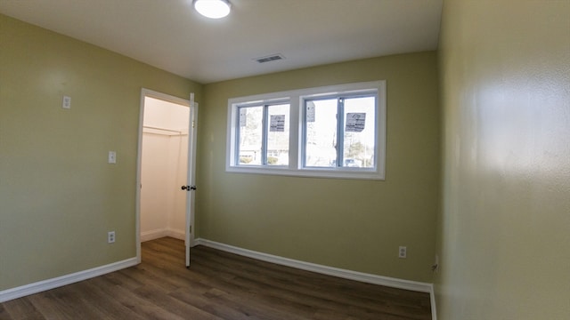 empty room with dark hardwood / wood-style floors