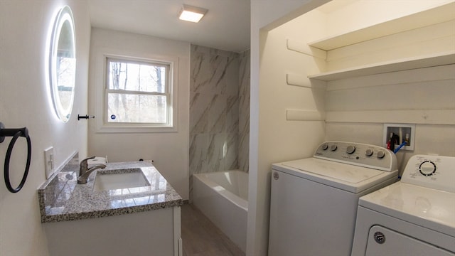 clothes washing area featuring sink and washing machine and clothes dryer