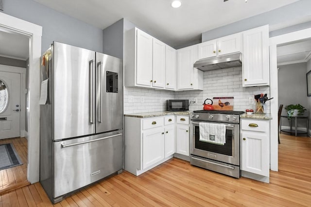 kitchen with appliances with stainless steel finishes, white cabinetry, and under cabinet range hood