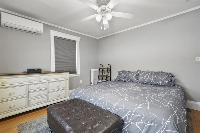 bedroom with ceiling fan, wood finished floors, radiator heating unit, a wall mounted air conditioner, and crown molding