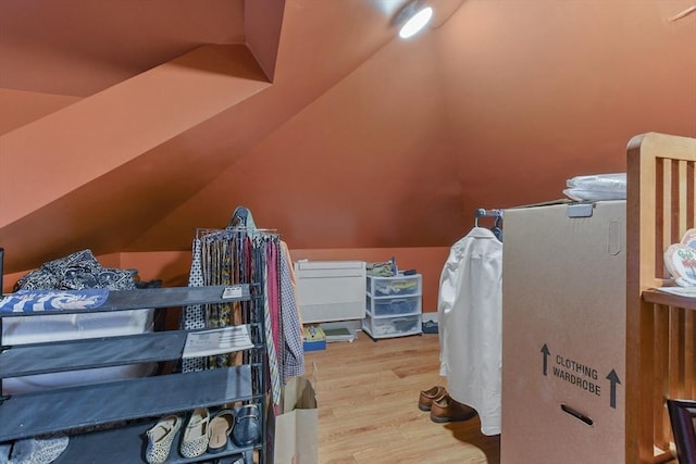 bedroom featuring lofted ceiling and wood finished floors