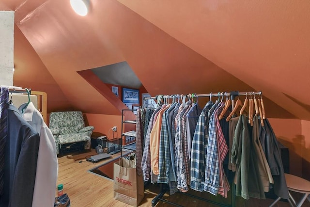 spacious closet with lofted ceiling and wood finished floors