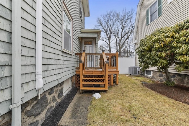 view of yard with fence and central air condition unit