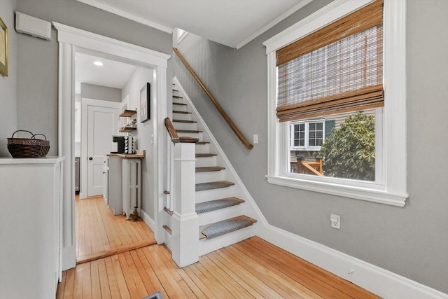 stairs featuring hardwood / wood-style flooring and baseboards