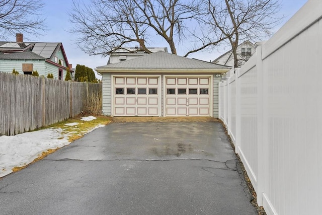 detached garage featuring fence