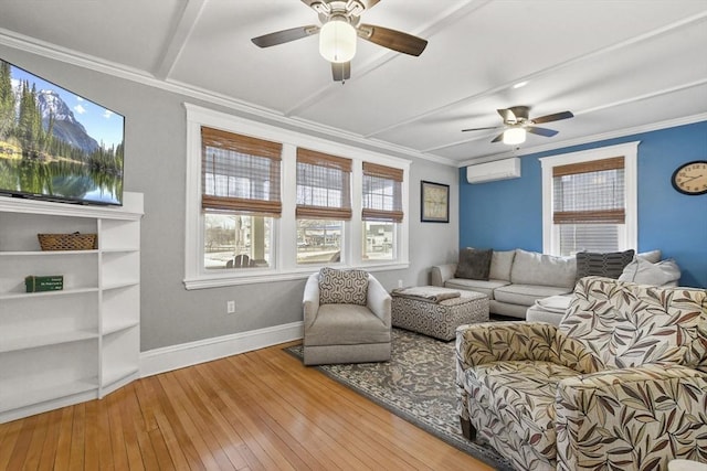 interior space featuring ceiling fan, a wall unit AC, baseboards, ornamental molding, and hardwood / wood-style floors