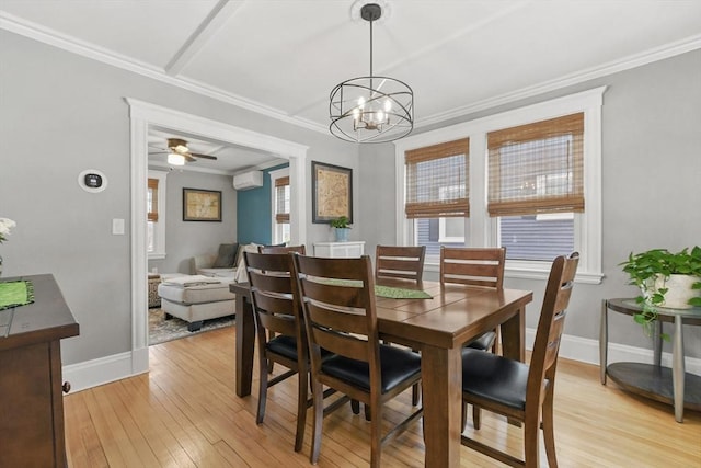 dining room featuring a wall unit AC, light wood-style floors, ornamental molding, baseboards, and ceiling fan with notable chandelier