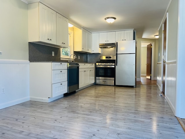 kitchen with white cabinetry, appliances with stainless steel finishes, and light hardwood / wood-style flooring