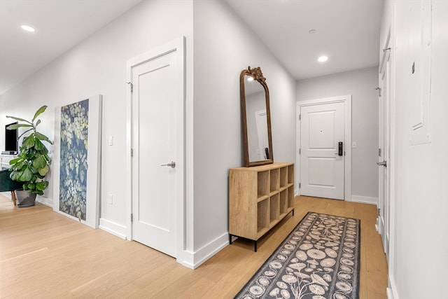 hallway with light hardwood / wood-style flooring