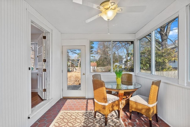 sunroom featuring a ceiling fan