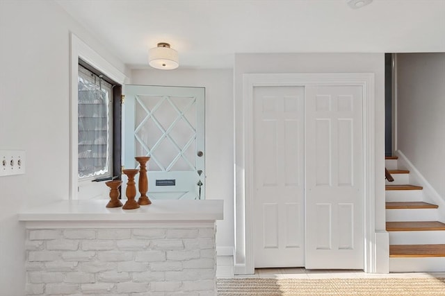 entryway with baseboards and stairs