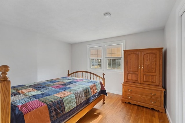 bedroom with wood finished floors and baseboards