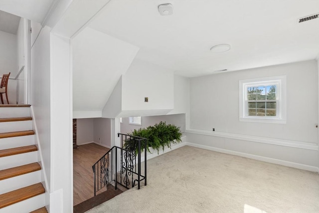 interior space with visible vents, baseboards, and carpet floors